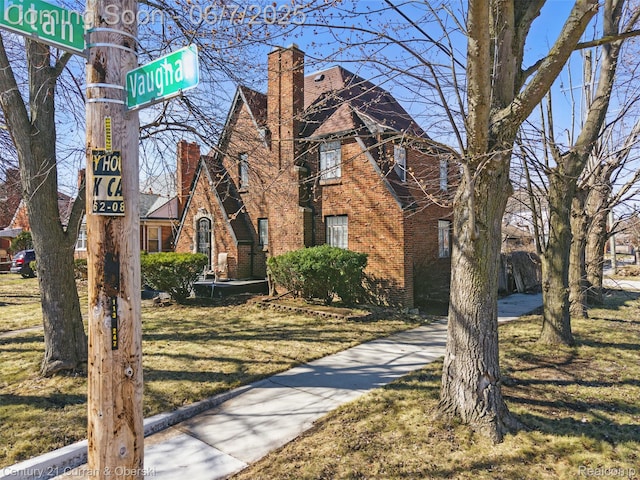 15915 Vaughan St, Detroit, MI 48223 - view of front of property with a chimney, a front yard, and brick siding