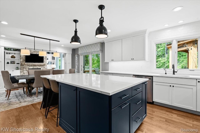1307 Trillium Ct, Wixom, MI 48393 - kitchen with dishwasher, white cabinetry, light countertops, a kitchen island, and recessed lighting