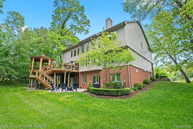 1307 Trillium Ct, Wixom, MI 48393 - back of house with a chimney, stairway, a deck, brick siding, and a patio