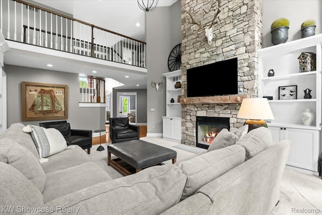 1307 Trillium Ct, Wixom, MI 48393 - living room with a stone fireplace, built in shelves, and recessed lighting