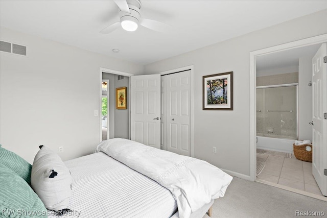 1307 Trillium Ct, Wixom, MI 48393 - bedroom featuring a closet, light tile patterned flooring, light colored carpet, ceiling fan, and ensuite bathroom