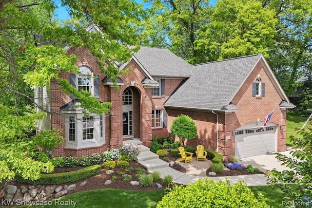 1307 Trillium Ct, Wixom, MI 48393 - traditional-style home featuring a shingled roof, brick siding, driveway, and an attached garage