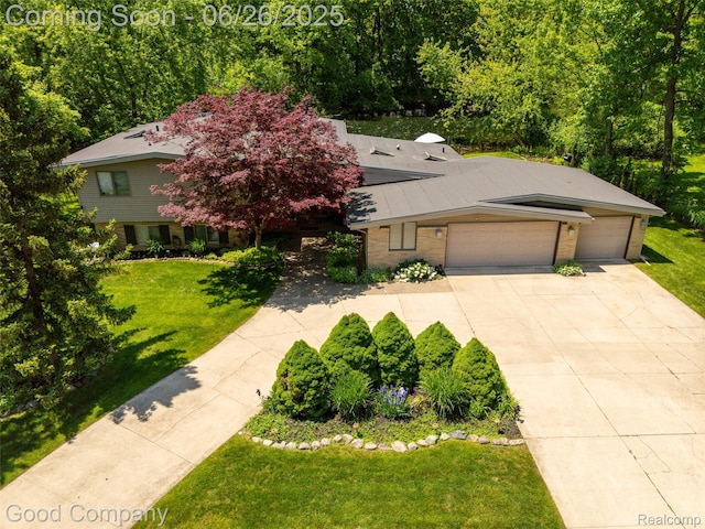 30239 Hickory Ln, Franklin, MI 48025 - view of front of home with concrete driveway, an attached garage, a front lawn, and brick siding