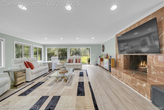 30239 Hickory Ln, Franklin, MI 48025 - living area with a large fireplace, plenty of natural light, recessed lighting, wood finished floors, and ornamental molding