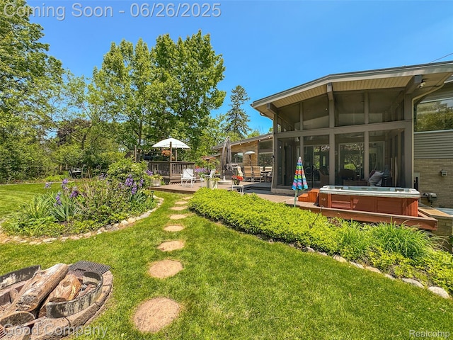 30239 Hickory Ln, Franklin, MI 48025 - view of green lawn with a hot tub, a patio, an outdoor fire pit, a sunroom, and a deck