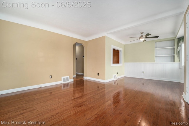 15255 Horger Ave, Allen Park, MI 48101 - unfurnished room featuring arched walkways, hardwood / wood-style floors, a ceiling fan, and baseboards