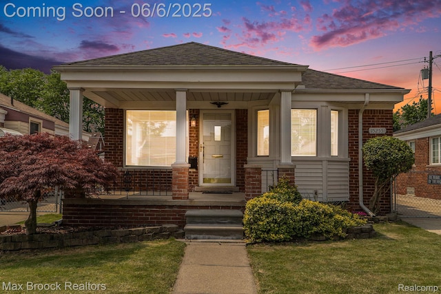 15255 Horger Ave, Allen Park, MI 48101 - bungalow featuring brick siding, covered porch, a shingled roof, and a front yard