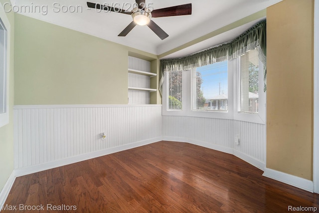 15255 Horger Ave, Allen Park, MI 48101 - empty room featuring dark wood finished floors, a ceiling fan, wainscoting, baseboards, and built in features
