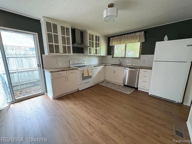 43242 Barchester Rd, Canton, MI 48187 - kitchen featuring white appliances, wall chimney exhaust hood, decorative backsplash, dark wood-style floors, and a textured ceiling