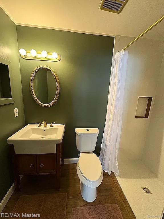 43242 Barchester Rd, Canton, MI 48187 - full bath with toilet, a shower stall, a sink, and baseboards