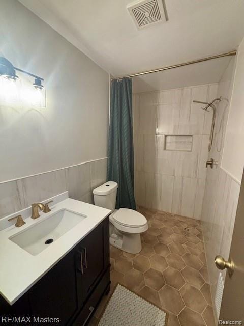 43242 Barchester Rd, Canton, MI 48187 - bathroom with a shower stall, toilet, vanity, tile patterned floors, and a wainscoted wall