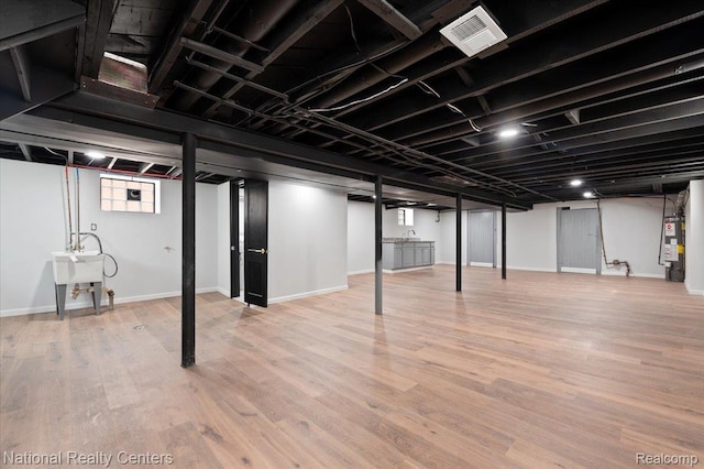 17169 Griggs St, Detroit, MI 48221 - basement with gas water heater, wood finished floors, and baseboards