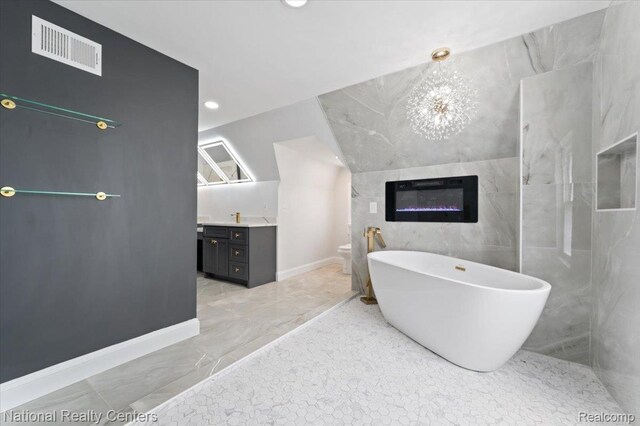 17169 Griggs St, Detroit, MI 48221 - full bathroom featuring vanity, marble look tile flooring, a freestanding bath, toilet, and tile walls