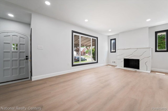 17169 Griggs St, Detroit, MI 48221 - unfurnished living room with light wood-style flooring, baseboards, recessed lighting, and a fireplace