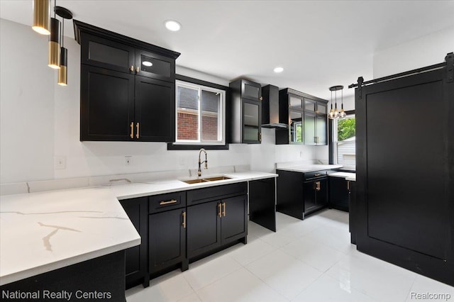 17169 Griggs St, Detroit, MI 48221 - kitchen featuring a sink, wall chimney exhaust hood, dark cabinetry, light stone counters, and recessed lighting