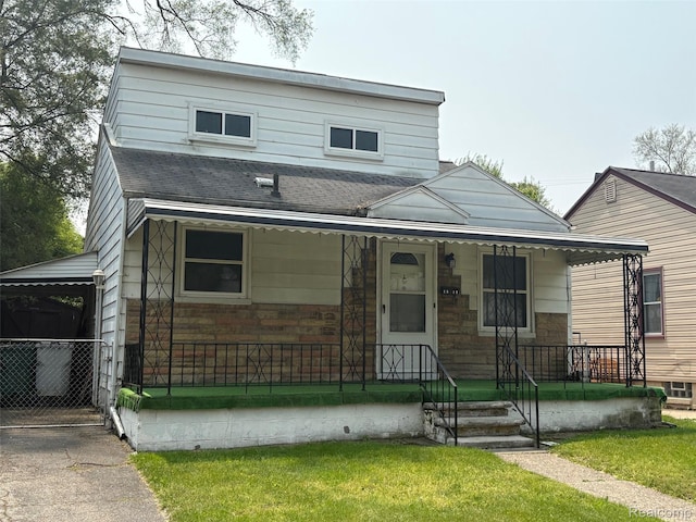 1512 E Evelyn Ave, Hazel Park, MI 48030 - view of front of home featuring a porch, a shingled roof, and a front yard