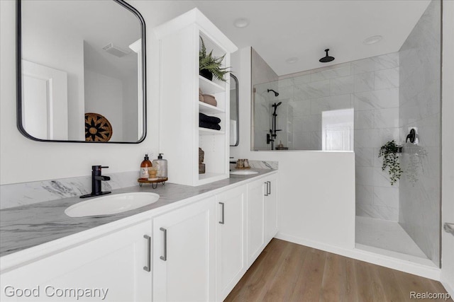 2819 16th St, Detroit, MI 48216 - full bathroom with double vanity, a walk in shower, and wood finished floors