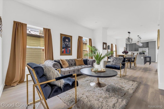 2827 16th St, Detroit, MI 48216 - living room with plenty of natural light, light wood-type flooring, and a chandelier
