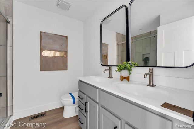 2827 16th St, Detroit, MI 48216 - full bathroom featuring double vanity, wood finished floors, and a stall shower
