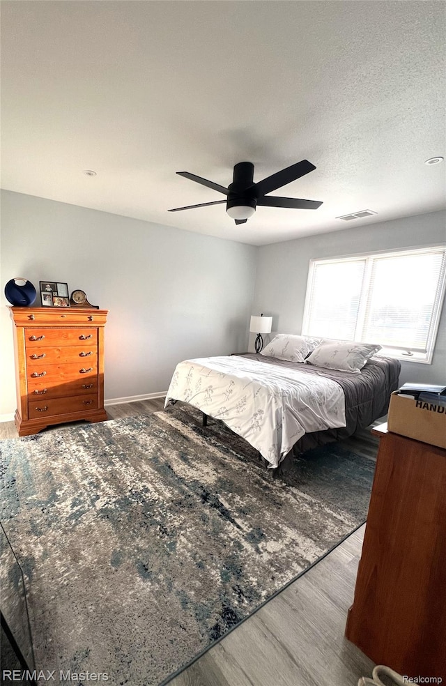 1565 Harbour Blvd Unit 182, Trenton, MI 48183 - bedroom featuring wood finished floors, a ceiling fan, and baseboards