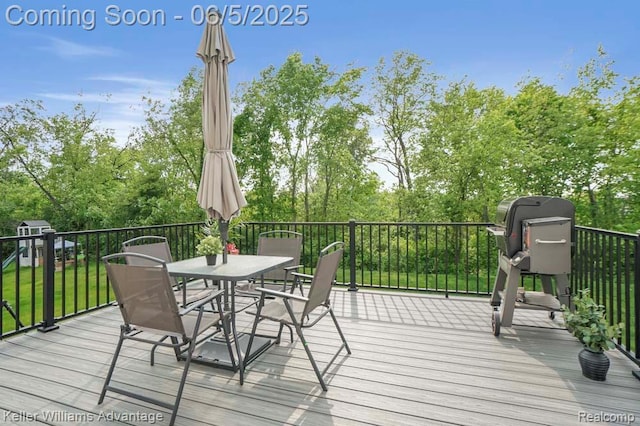861 N Mill St, South Lyon, MI 48178 - wooden terrace featuring outdoor dining space and view of scattered trees