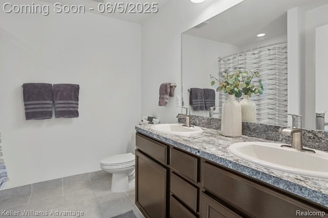 861 N Mill St, South Lyon, MI 48178 - full bath featuring toilet, double vanity, and tile patterned flooring