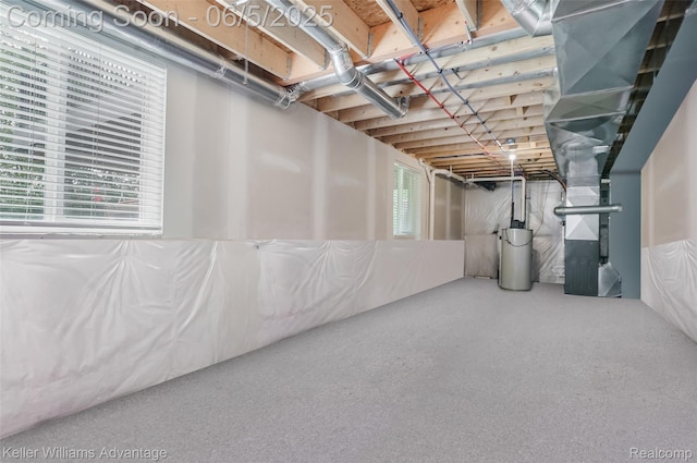 861 N Mill St, South Lyon, MI 48178 - basement featuring healthy amount of natural light, heating unit, and water heater