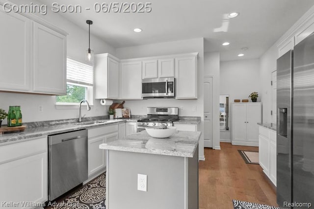 861 N Mill St, South Lyon, MI 48178 - kitchen featuring appliances with stainless steel finishes, a sink, white cabinets, recessed lighting, and hanging light fixtures
