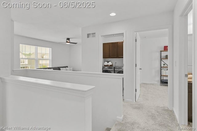 861 N Mill St, South Lyon, MI 48178 - corridor featuring washer and clothes dryer, light colored carpet, recessed lighting, and baseboards