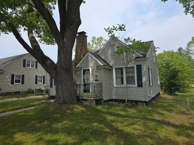 846 Catherine Ave, Muskegon, MI 49442 - view of front of property with central AC, a chimney, and a front yard