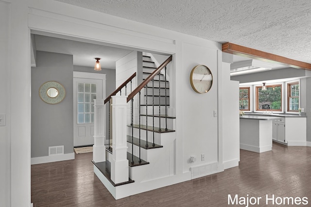 7125 Brooklyn Ave SE, Grand Rapids, MI 49508 - stairs featuring baseboards, wood finished floors, and a textured ceiling