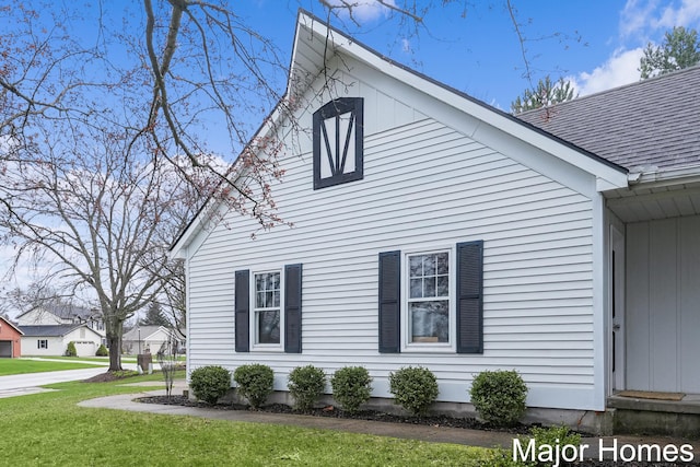 7125 Brooklyn Ave SE, Grand Rapids, MI 49508 - view of side of home featuring a yard and a shingled roof