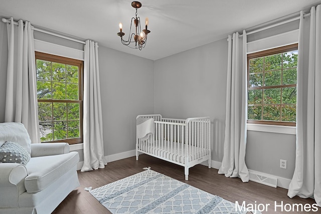 7125 Brooklyn Ave SE, Grand Rapids, MI 49508 - bedroom with a chandelier, multiple windows, baseboards, and a crib