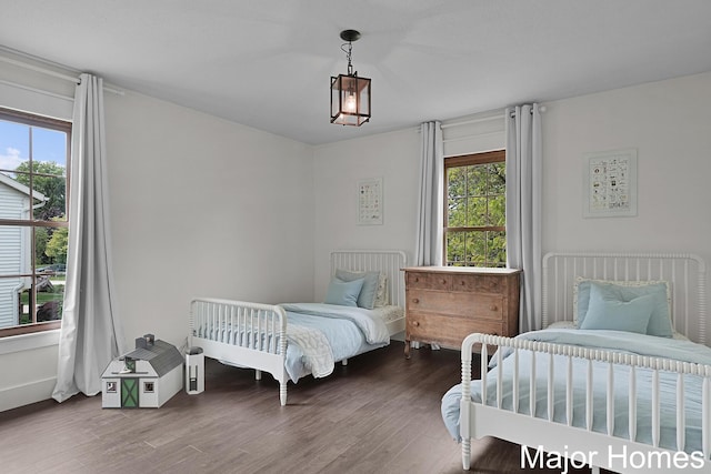 7125 Brooklyn Ave SE, Grand Rapids, MI 49508 - bedroom featuring multiple windows, wood finished floors, and baseboards