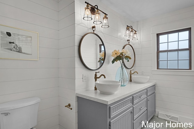 7125 Brooklyn Ave SE, Grand Rapids, MI 49508 - bathroom featuring double vanity and toilet