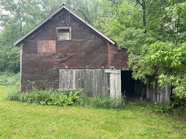 855 E Hansen Rd, Scottville, MI 49454 - view of side of property with a barn, an outbuilding, a yard, and brick siding