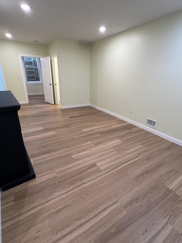 855 E Hansen Rd, Scottville, MI 49454 - spare room with baseboards, recessed lighting, and wood finished floors