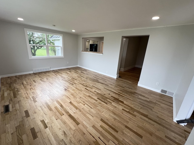 855 E Hansen Rd, Scottville, MI 49454 - empty room featuring wood finished floors, baseboards, ornamental molding, and recessed lighting