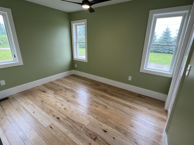 855 E Hansen Rd, Scottville, MI 49454 - unfurnished room featuring hardwood / wood-style flooring, a ceiling fan, and baseboards