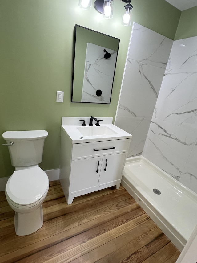 855 E Hansen Rd, Scottville, MI 49454 - full bath featuring vanity, toilet, wood finished floors, and a marble finish shower