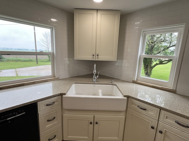 855 E Hansen Rd, Scottville, MI 49454 - kitchen featuring black dishwasher, a sink, healthy amount of natural light, and tasteful backsplash