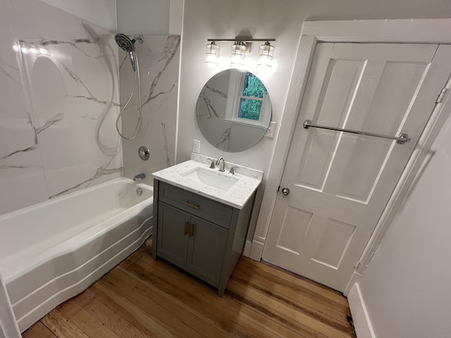 855 E Hansen Rd, Scottville, MI 49454 - bathroom featuring vanity, wood finished floors, and shower / tub combination