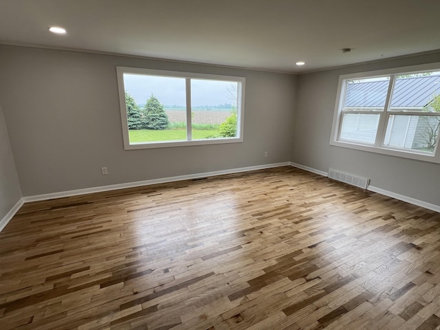 855 E Hansen Rd, Scottville, MI 49454 - unfurnished room featuring wood finished floors, baseboards, and recessed lighting