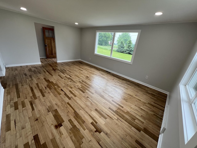 855 E Hansen Rd, Scottville, MI 49454 - empty room with wood finished floors, baseboards, and recessed lighting