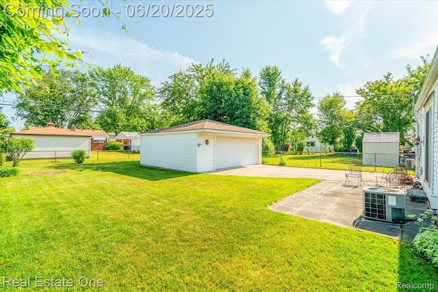 32622 Parkwood St, Westland, MI 48186 - view of yard featuring an outbuilding, a garage, and a patio area