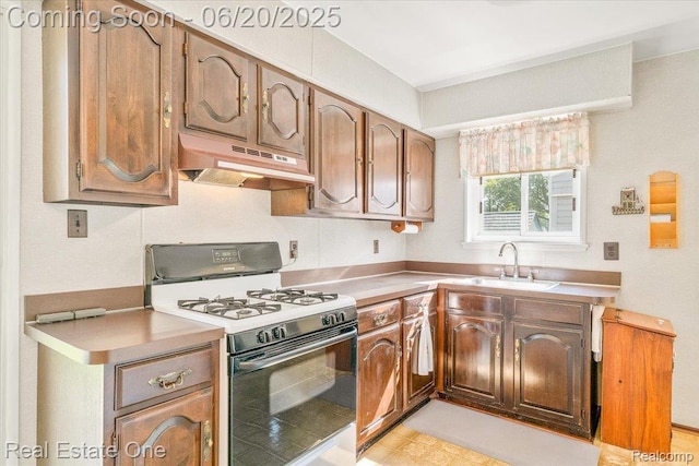 32622 Parkwood St, Westland, MI 48186 - kitchen with range with gas stovetop, under cabinet range hood, light countertops, and brown cabinetry