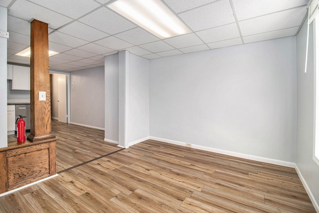 707 Maple St, Big Rapids, MI 49307 - finished below grade area with light wood-style flooring, baseboards, and a drop ceiling