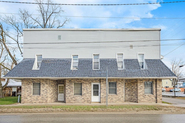 707 Maple St, Big Rapids, MI 49307 - view of front of home featuring roof with shingles and brick siding