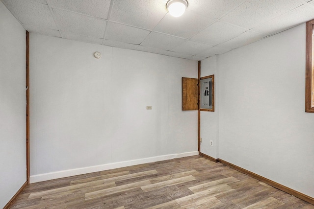 707 Maple St, Big Rapids, MI 49307 - unfurnished room with a paneled ceiling, light wood-type flooring, baseboards, and electric panel