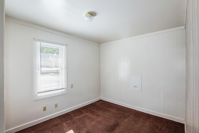 707 Maple St, Big Rapids, MI 49307 - unfurnished room featuring dark colored carpet and baseboards